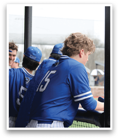 Baseball players wearing blue uniforms and blue hats are sitting on a bench. AI generated content