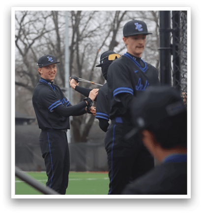 A group of men are standing on a field, one of them holding a baseball bat. AI generated content