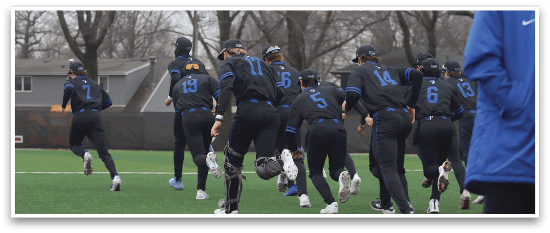 A group of female softball players wearing blue uniforms are walking across a field. AI generated content