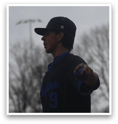 A man wearing a baseball cap and a black shirt is standing on a field. AI generated content