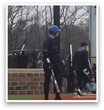 A baseball player in a blue helmet and black uniform is standing at home plate, holding a bat. AI generated content