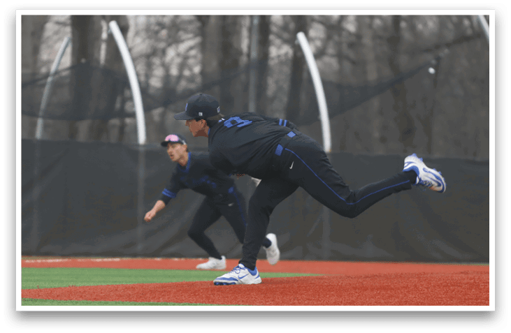 A baseball player in a black shirt and blue hat is throwing a ball on the field. AI generated content