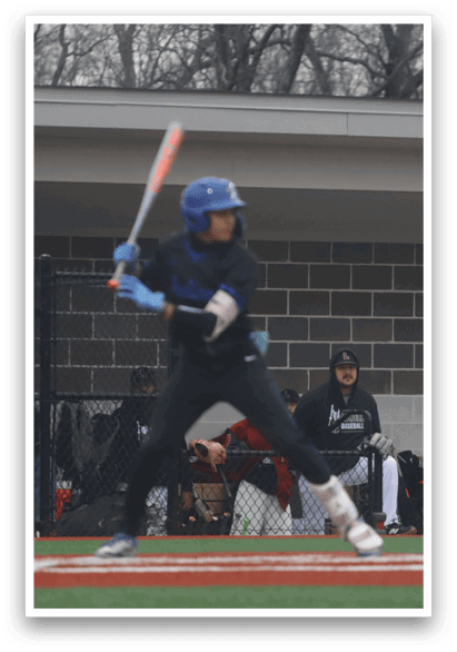 A baseball player in a black shirt and blue helmet is swinging a bat at a ball. AI generated content