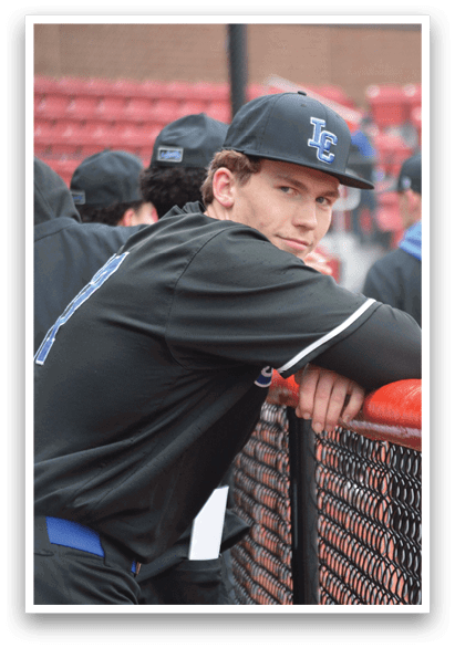 A baseball player wearing a black jersey with the number 2 on it leans on a fence. AI generated content