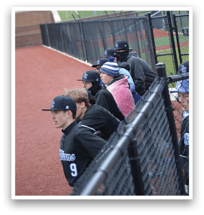 A group of people are sitting on a bench, watching a baseball game. AI generated content