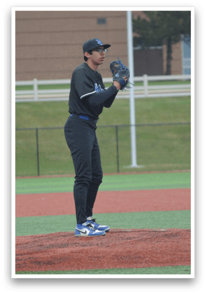 A baseball player in a black shirt and black pants is standing on the pitcher's mound, holding a baseball in his hand. AI generated content
