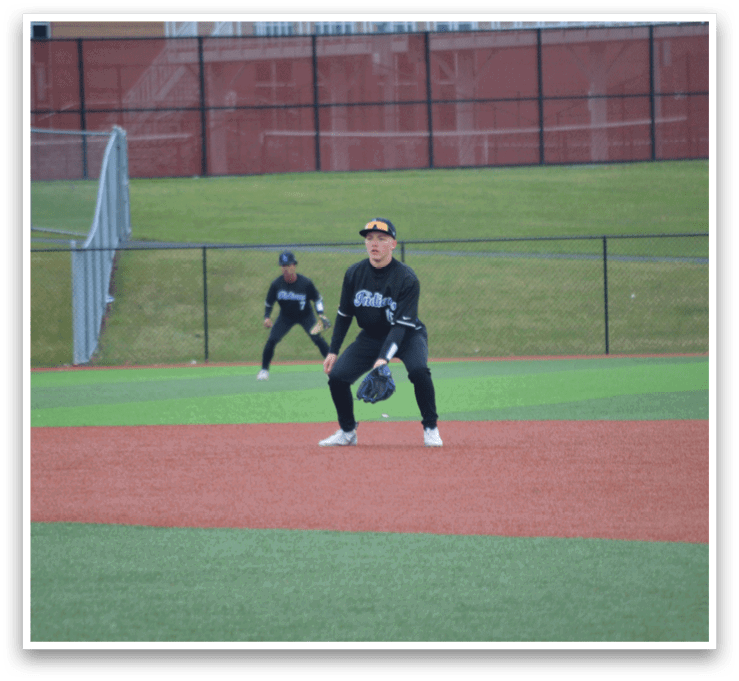 A baseball player in a black shirt and white pants is standing on the field, holding a bat. AI generated content