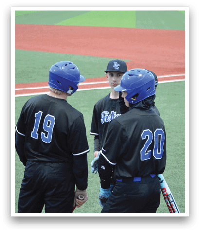 Two baseball players wearing black uniforms and blue helmets are talking to each other on the field. AI generated content