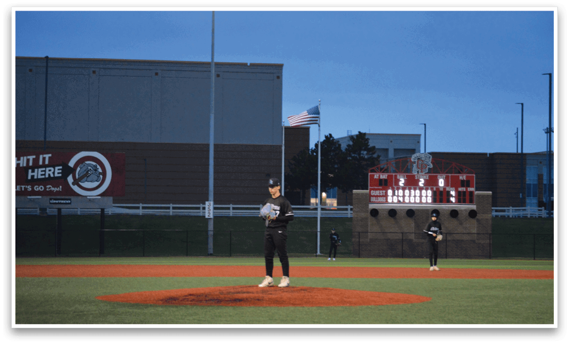 A baseball player is standing on the pitcher's mound, holding a baseball in his hand. AI generated content