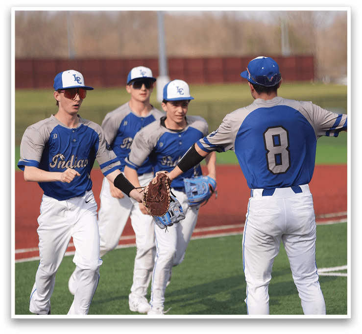 A group of baseball players wearing blue and grey uniforms are walking on a field. AI generated content