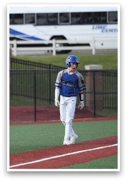 A baseball player wearing a blue helmet and white uniform walks across the field. AI generated content