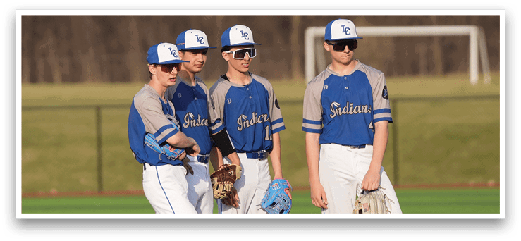 Three baseball players wearing blue and grey uniforms stand on a field. AI generated content