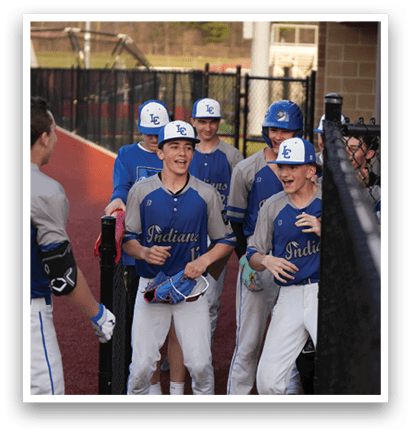 A group of young men wearing baseball uniforms are standing in front of a fence. AI generated content