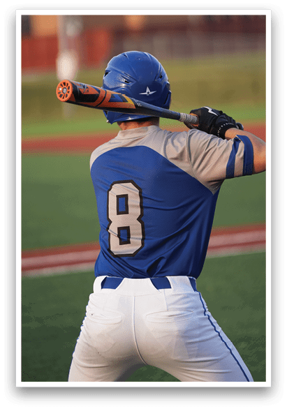 A baseball player in a blue and grey uniform is holding a bat, ready to swing. AI generated content