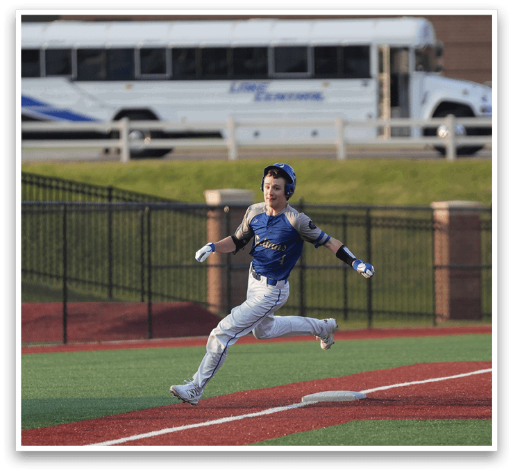 A baseball player running towards home plate, wearing a blue and white uniform. AI generated content