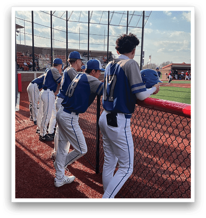 A group of baseball players are standing on the field, wearing blue and white uniforms. They are watching the game from the sidelines. AI generated content