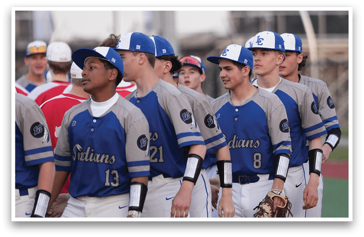 A group of baseball players wearing blue and grey uniforms are standing on a field. AI generated content