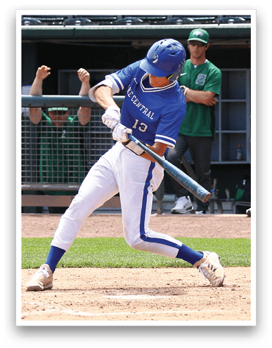 A person wearing a blue and white baseball uniform is swinging a bat to hit a baseball during a game with spectators cheering behind a fence. Description generated by AI