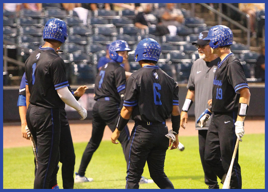 A baseball player wearing a blue helmet and black jersey. Description generated by AI