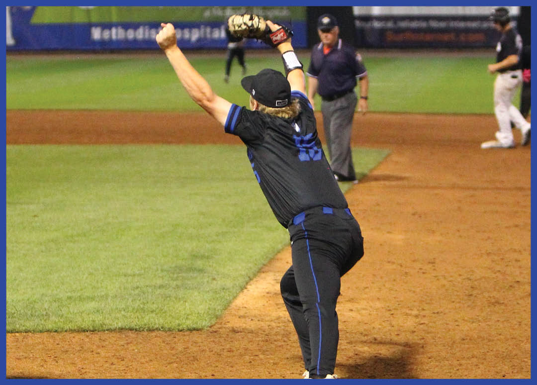 A baseball player wearing a blue helmet and black jersey. Description generated by AI