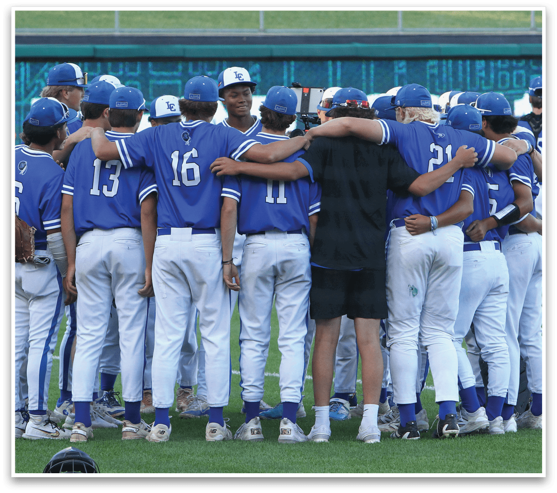 A group of baseball players wearing blue and black uniforms. Description generated by AI
