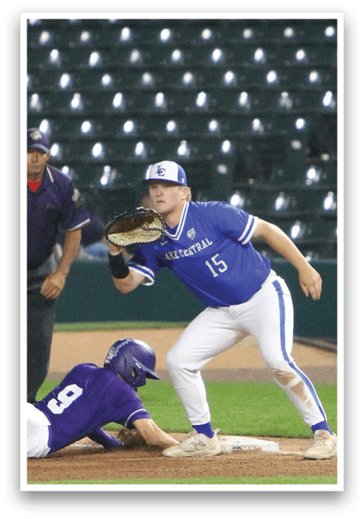 A baseball player is at bat, wearing a blue helmet and black uniform. Description generated by AI