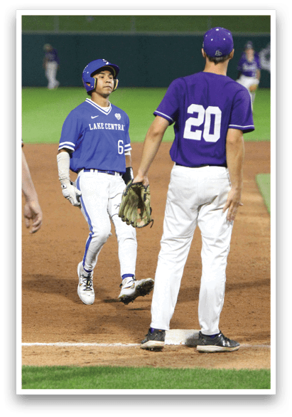 A baseball player is at bat, wearing a blue helmet and black uniform. Description generated by AI