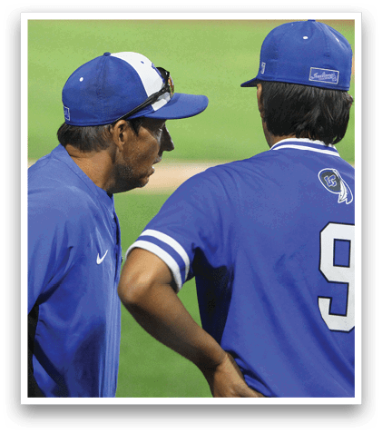 A baseball player wearing a blue helmet and black jersey. Description generated by AI