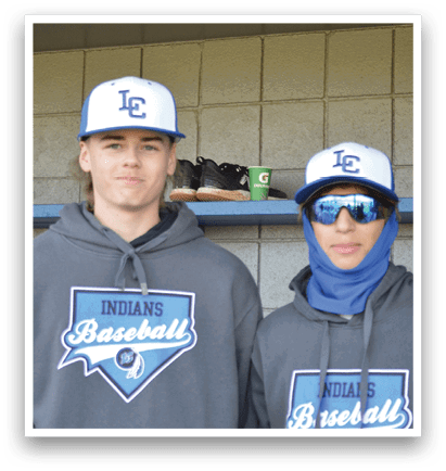 Two young men wearing baseball hats and sweatshirts stand next to each other. AI generated content