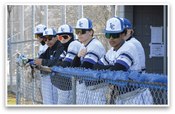 A group of baseball players wearing blue and white uniforms are standing on a field. AI generated content