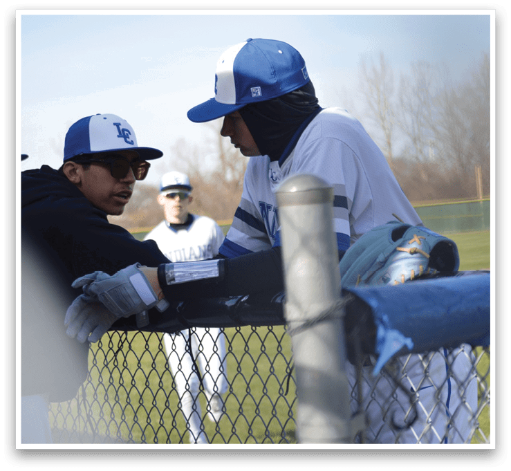 Two baseball players are talking to each other while one of them is wearing a blue hat. AI generated content