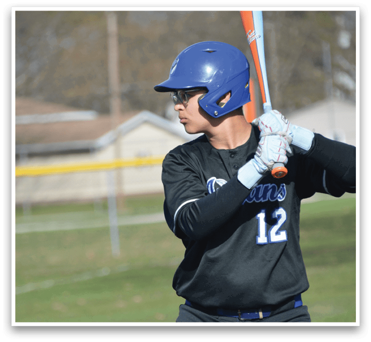 A baseball player in a black and grey uniform is holding a bat and preparing to swing at a ball. AI generated content