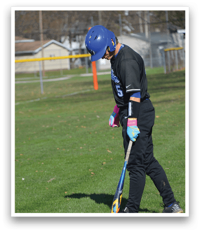 A person wearing a blue helmet and holding a baseball bat, standing on a grassy field. AI generated content