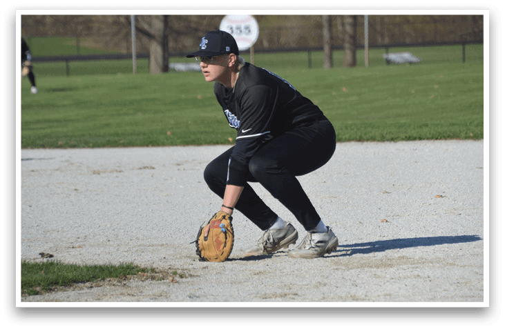 A baseball player in a black shirt and hat is kneeling on the ground, holding a baseball mitt. AI generated content