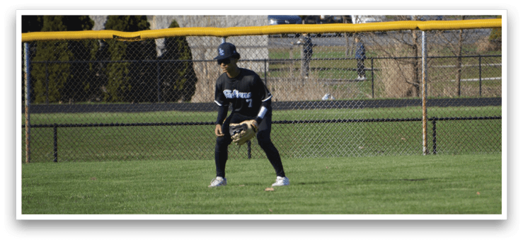 A person wearing a baseball glove is standing in a grassy field. AI generated content