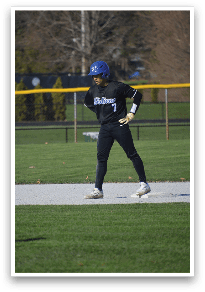 A baseball player in a black uniform is standing on a field, holding a bat and getting ready to hit the ball. AI generated content