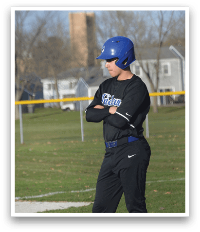 A baseball player wearing a blue helmet and black uniform stands on a field. AI generated content