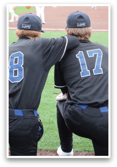 Two baseball players wearing number 18 and 17 jerseys are sitting on the field. AI generated content