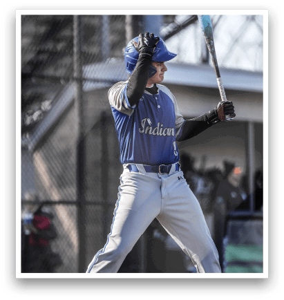 A baseball player in a blue and white uniform is holding a bat, ready to swing. AI generated content