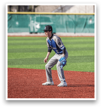 A baseball player is standing on the field, wearing a blue and grey uniform. AI generated content