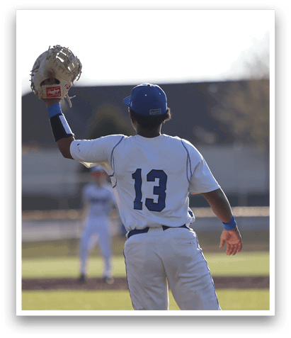 A baseball player wearing a blue and white uniform is holding a baseball glove, preparing to catch a ball. AI generated content
