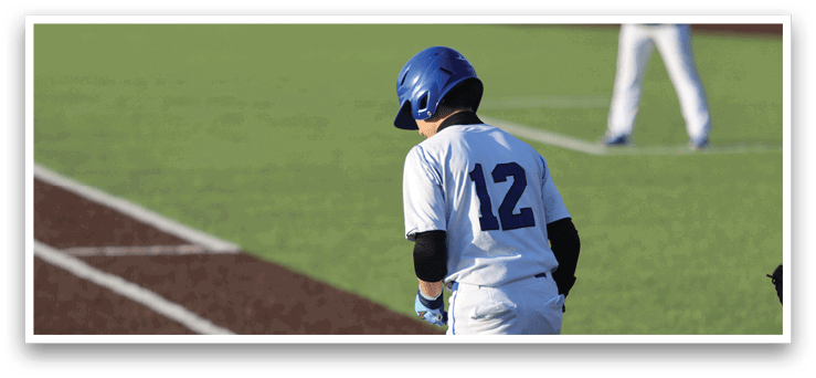 A baseball player wearing a blue helmet and white uniform stands on the field. AI generated content