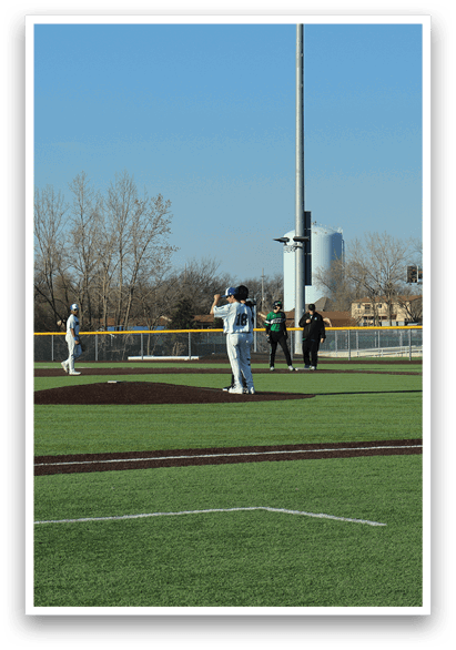 A baseball game is taking place on a field with a batter, catcher, and umpire. The batter is holding a baseball bat and getting ready to swing. AI generated content