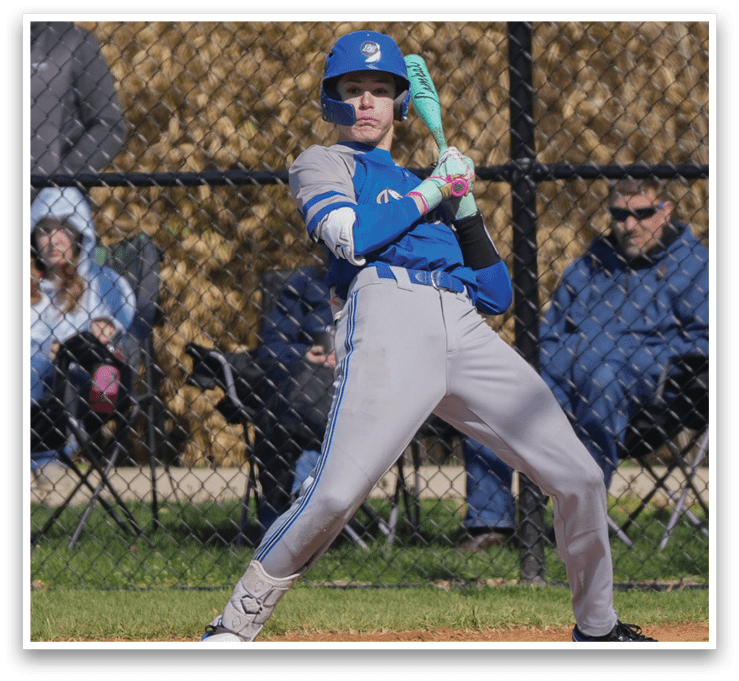 A baseball player in a blue and grey uniform is swinging a bat, with a crowd of people watching. AI generated content