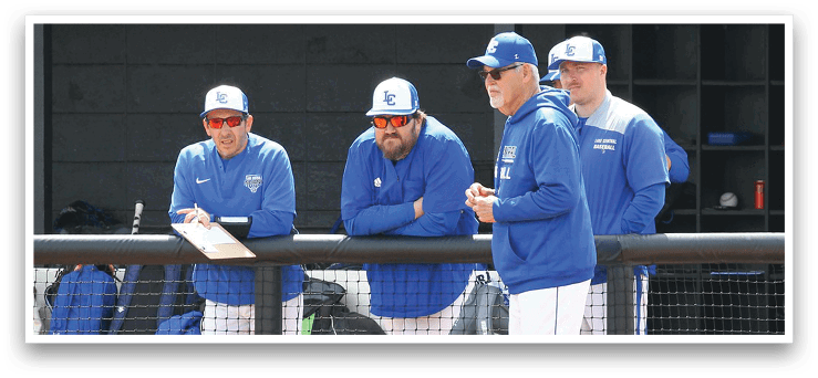A group of men wearing blue and white baseball uniforms are standing on a baseball field. AI generated content