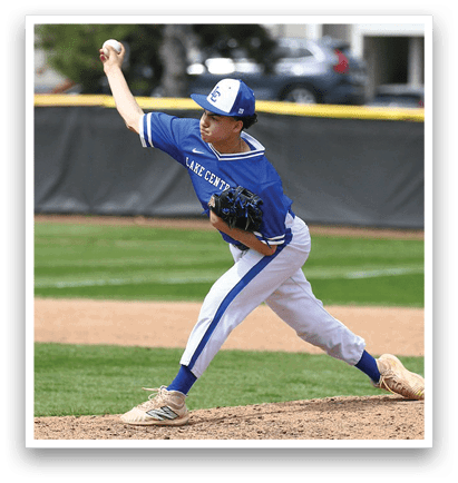 A baseball player in a blue and white uniform is pitching a ball. AI generated content