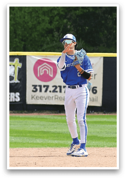 A baseball player in a blue uniform is standing on a field, holding a baseball glove and preparing to catch a ball. AI generated content
