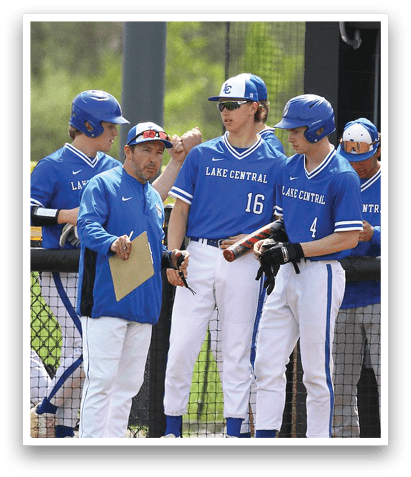 A group of baseball players are standing on a field, some of them wearing blue uniforms. They are holding baseball bats and gloves, and a baseball is visible in the scene. The players are engaged in conversation, possibly discussing their game strategy or sharing their experiences. AI generated content