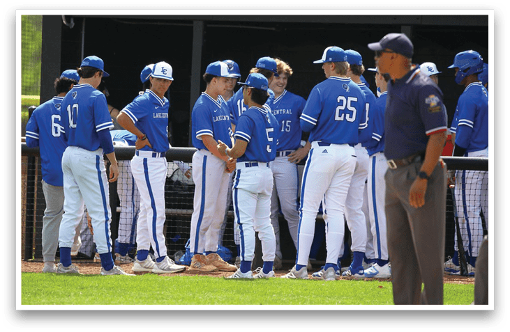 A group of baseball players wearing blue uniforms are standing on a field. AI generated content