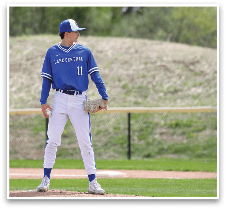 A baseball player in a blue uniform stands on the pitcher's mound, holding a baseball glove. AI generated content